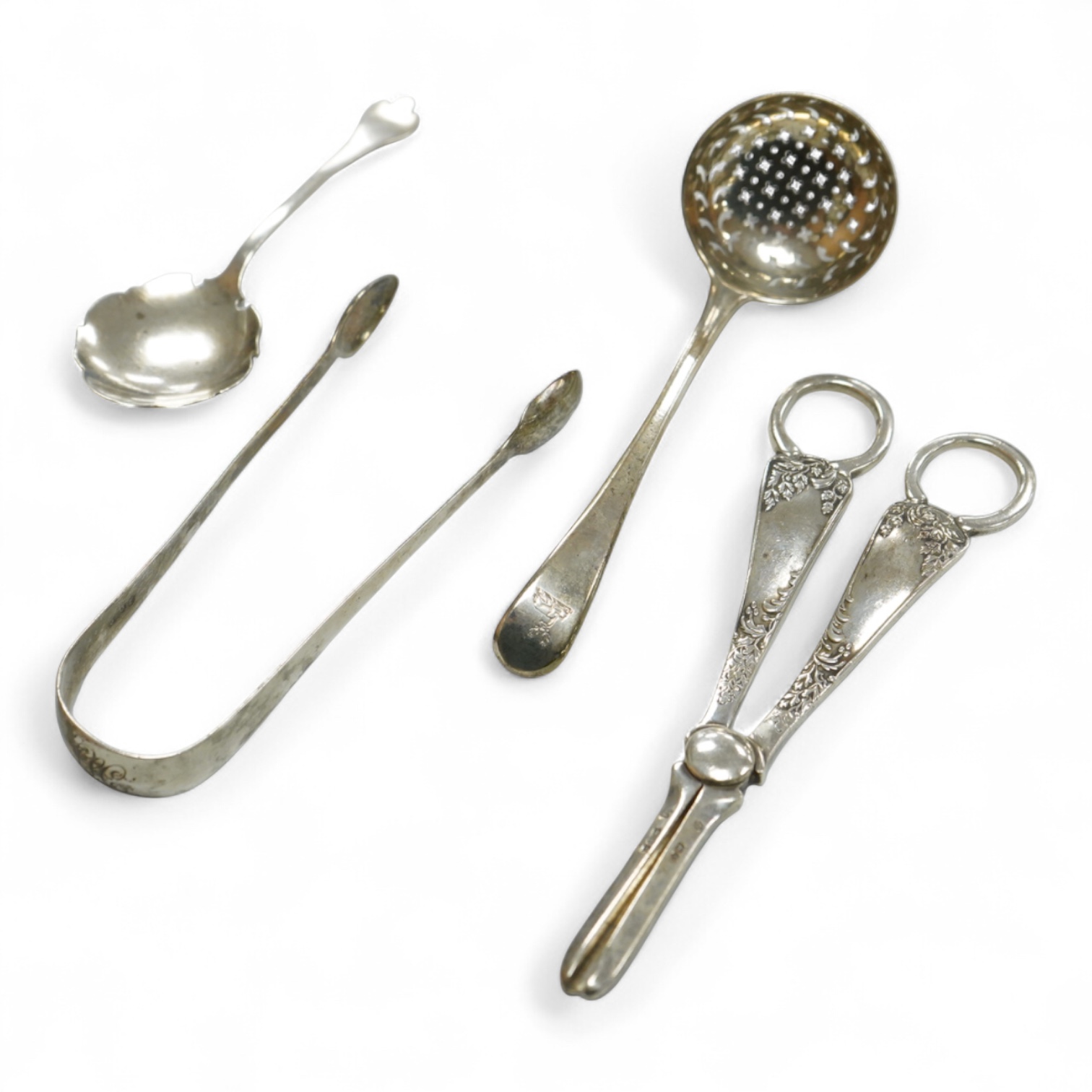 A pair of George V silver grape shears, Josiah Williams & Co, London, 1912, 16.2cm, together with a George III silver Old English pattern sifter spoon, Eley & Fearn, London, 1801, a similar pair of sugar tongs, London, 1